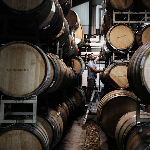 Exprimere Proprietor John Dimos with Wine Barrels