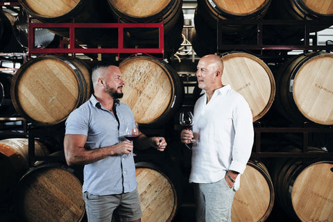 Exprimere proprietor and winemaker with barrels